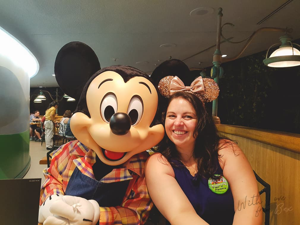 mickey mouse at table with young woman