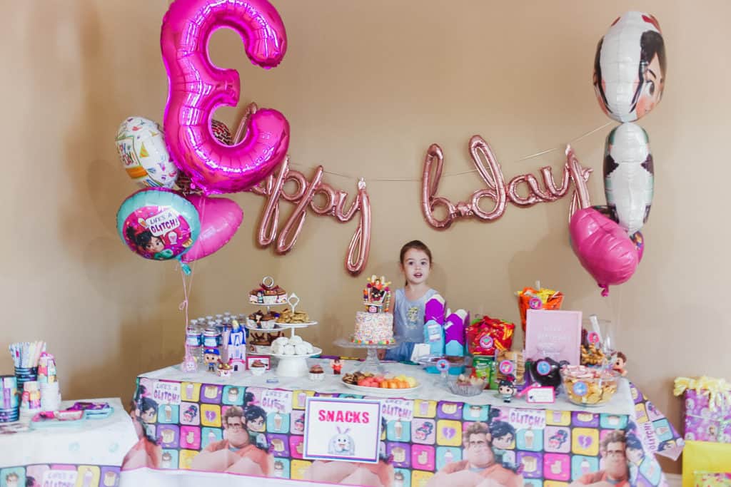 ptoddler behind candy table at birthday party